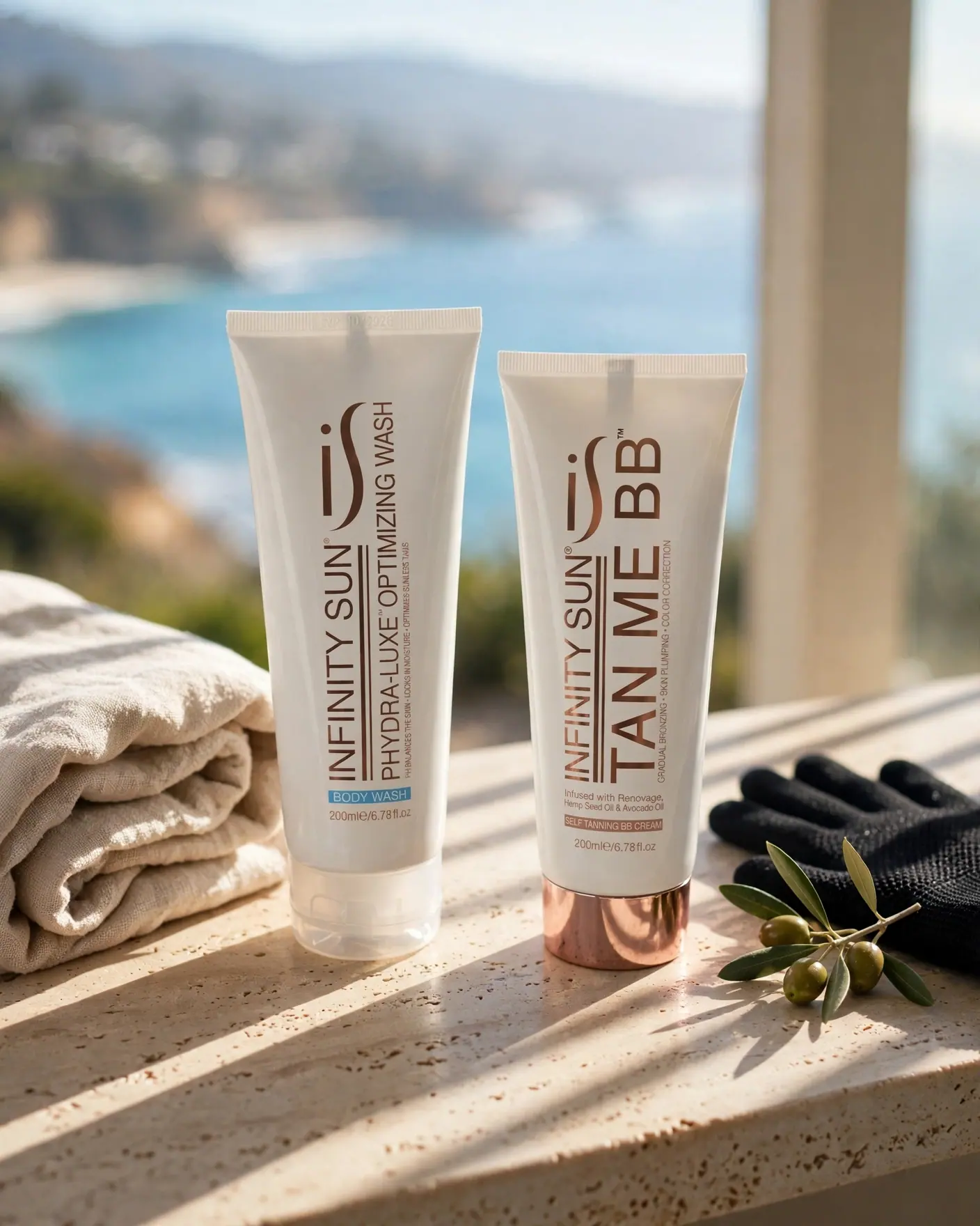 A black exfoliating mitt beside Phydra-Luxe body wash and Tan Me BB Cream on a sunny window ledge above the sea
